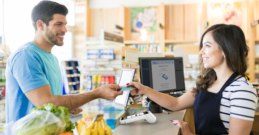 Customer paying via POS terminal at retail store—benefits of modern POS system for sales and efficiency